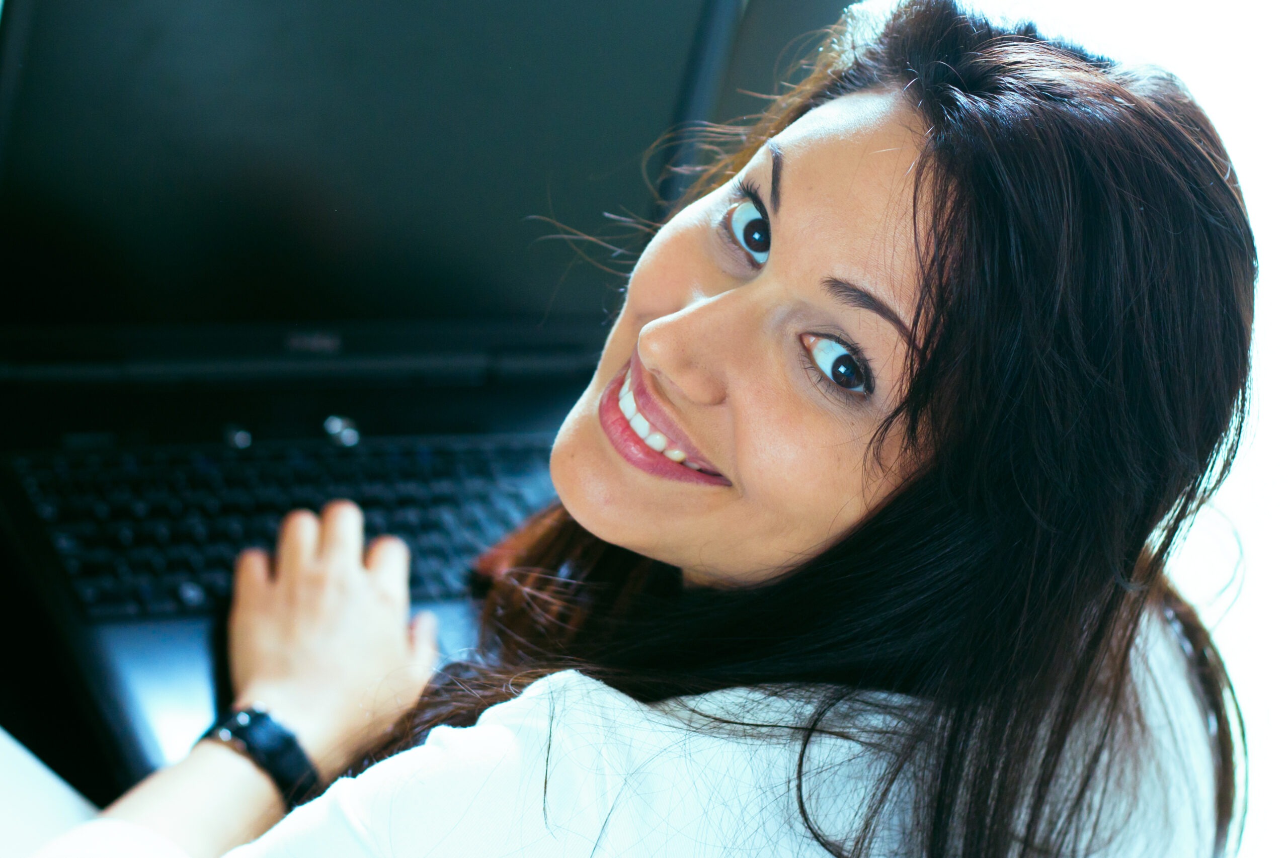 The beautiful business woman with the computer at office